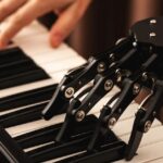 robot hand plays on Piano