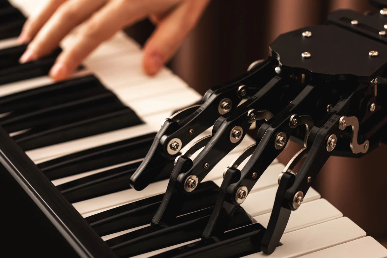 robot hand plays on Piano